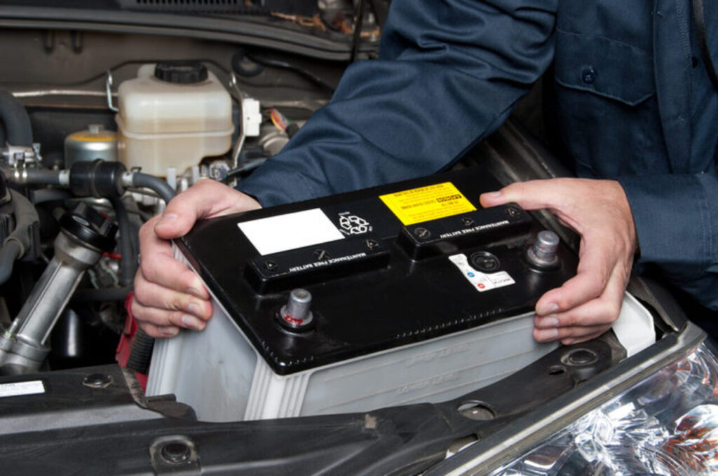 técnico removendo a bateria do carro